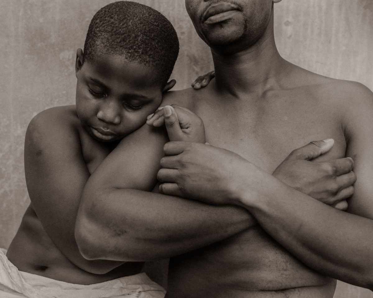 You are My Father by Angelika Kollin 

You are my Father series was a natural evolution and expansion of the preceding You are my Mother series and started unfolding in the second half of 2020. Since the main focus of Angelika’s artistic exploration were always women, taking a look into the world of manhood/fatherhood was a step into uncharted territory. Not having a close relationship with her own father, having an intimate and revealing insight into somebody else's Father/child connection, brought new insights and realizations, that turned out to be of great transforming power in her own life. As to the current date, all portraits for the series were taken in Cape Town, South Africa. Only like few other places, Cape Town offers one of the most unique melting pots, with people coming from a wide range of economic, cultural, and religious backgrounds. It was compelling to observe in this body of work how very same we all are in fundamental things of life: love for our children, the desire to give them a better life, and complete willingness to sacrifice your own for it.